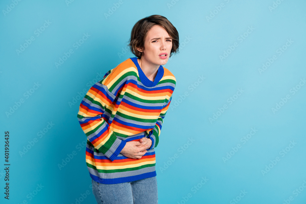 Portrait of depressed frustrated girl touching belly feeling bad healthcare spasm period isolated over bright blue color background - obrazy, fototapety, plakaty 