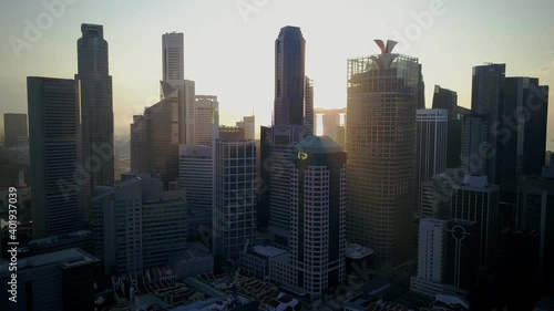 Drone footage of old buildings against tall skyscrapers in the city Singapore photo