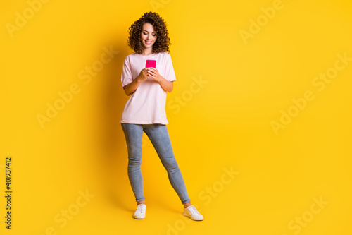 Fototapeta Full length body size photo of female hipster typing sms on smartphone smiling i