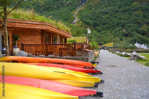 Gudvangen, Norway - traditional wooden houses showing the medieval life in the viking village. Colorful kayaks on the foreground.
