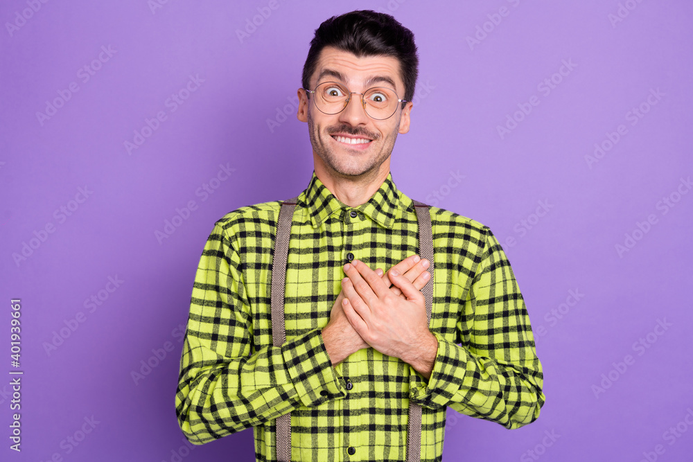 Photo portrait of excited amazed guy holding two hands on heart isolated on vivid violet colored background Photo portrait of excited amazed guy holding two hands on heart isolated on vivid violet colored background