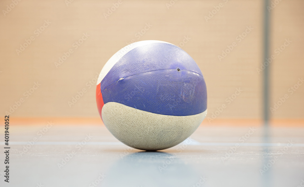 Old basketball on a gym floor