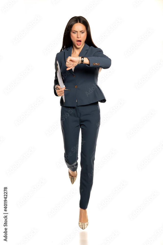 Young shocked business woman looking in her wristwatch and run Young shocked business woman looking in her wristwatch and run