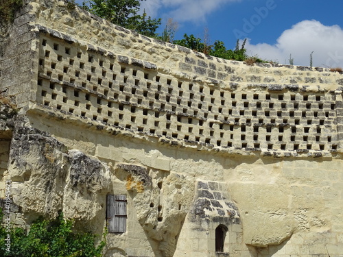 old stone dovecote built in the limestone wall in the Loire valley, France above a troglodyte cave 
