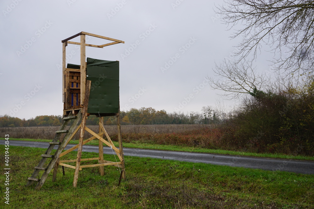 old wooden hunting lookout in the field in the countryside in France old wooden hunting lookout in the field in the countryside in France