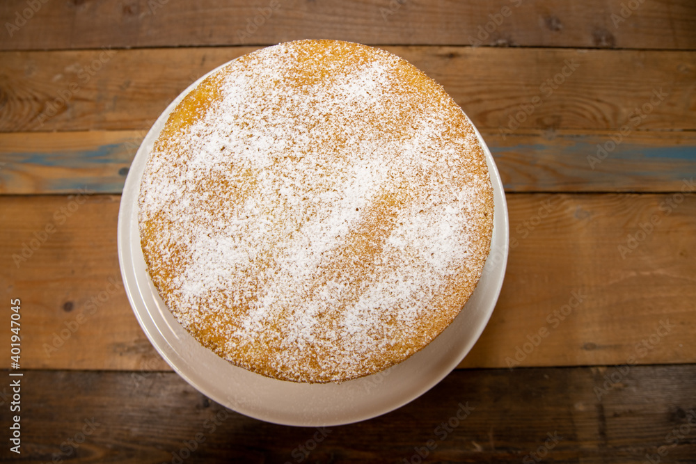 A delicious basic sponge cake with cream in a kitchen A delicious basic sponge cake with cream in a kitchen