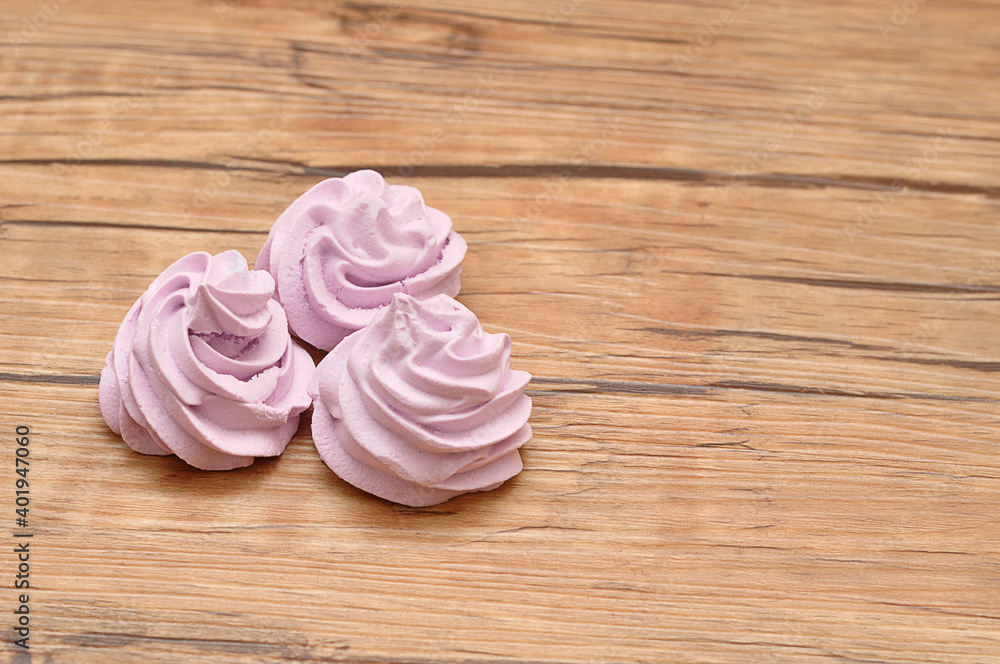 Three purple meringues on a table Three purple meringues on a table