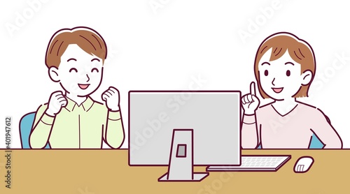 Two people talking while looking at a desktop computer