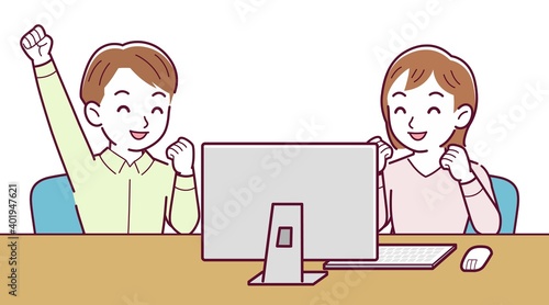Two people talking while looking at a desktop computer