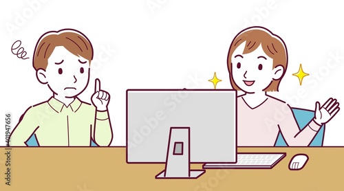 Two people talking while looking at a desktop computer