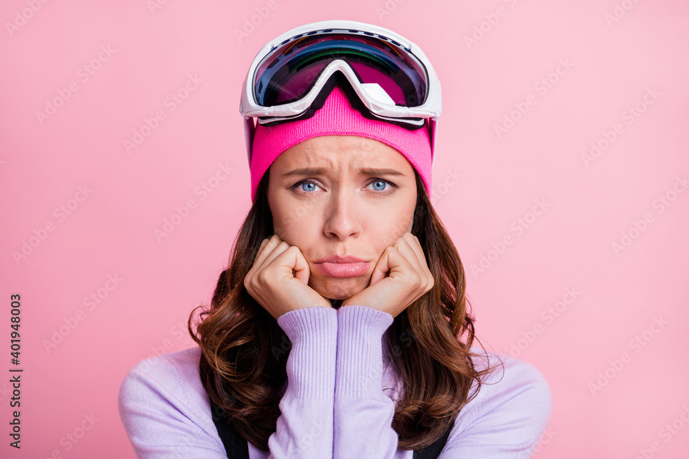 Photo portrait of upset crying girl holding face with two hands isolated on pastel pink colored background Photo portrait of upset crying girl holding face with two hands isolated on pastel pink colored background