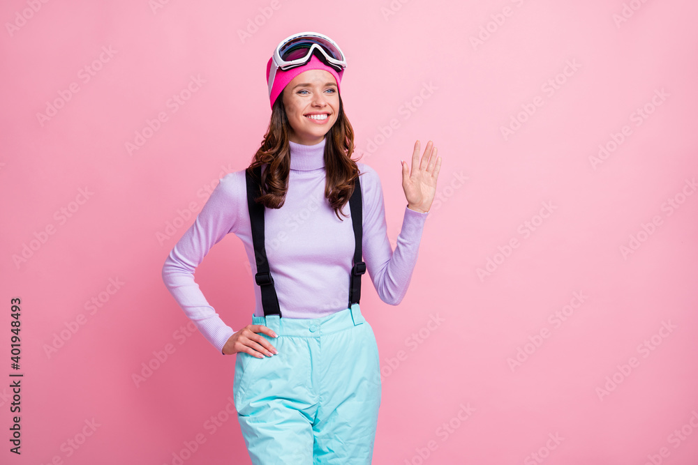 Photo portrait of cheerful girl waving hand isolated on pastel pink colored background Photo portrait of cheerful girl waving hand isolated on pastel pink colored background