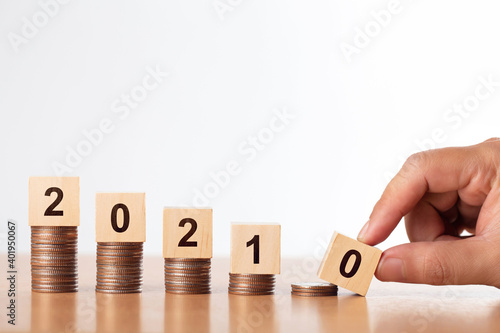 Wooden block year 2021 on coins stack.Investment and retirement. Business investment growth concept. Budget 2021.