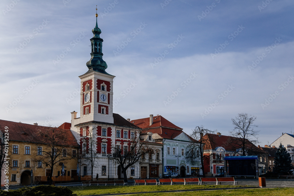 Obraz premium Old Town Hall with Clock Tower at the main Masaryk square of historic medieval royal town Slany, colorful renaissance houses in sunny winter day, Central Bohemia, Czech Republic