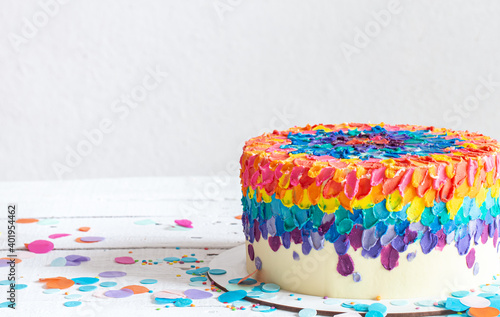 Colorful big handmade birthday cake copy space.