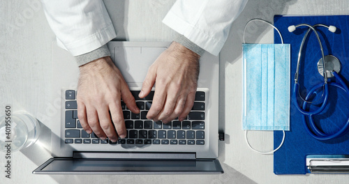 Professional doctor working at office desk photo