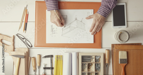 Creative carpenter and designer working at desk photo