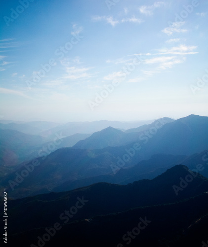 Beautiful landscape of blue mountains layers with clouds