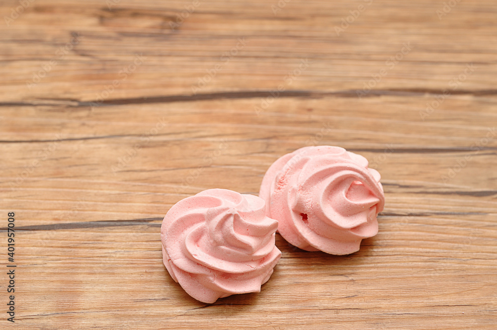Two pink meringues on a table Two pink meringues on a table