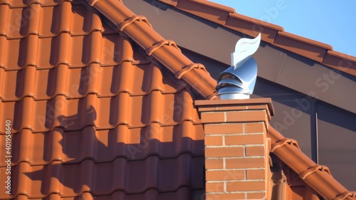 Obraz na plátně Wind Directional Cowl on Chimney Rotating Gently on Wind