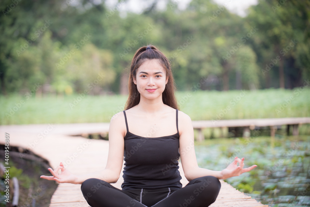 Asian woman is warm up, To make the muscles flexible Before going to jogging for good health and energy metabolism,Outdoors cross training workout. Healthcare concept Asian woman is warm up, To make the muscles flexible Before going to jogging for good health and energy metabolism,Outdoors cross training workout. Healthcare concept