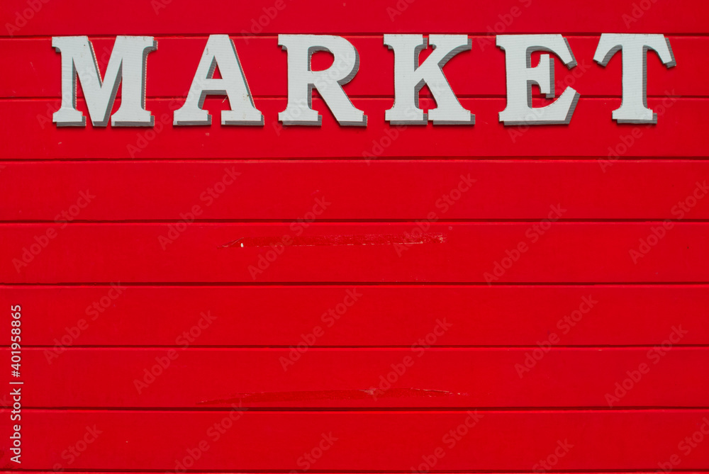 market text on red wooden wall market text on red wooden wall