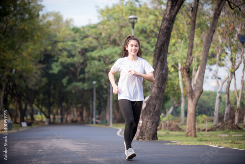 Fototapeta Naklejka Na Ścianę i Meble -  Asian woman is warm up, To make the muscles flexible Before going to jogging for good health and energy metabolism,Outdoors cross training workout. Healthcare concept