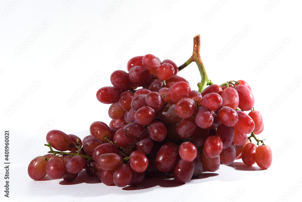 Fresh grapes and purple grape juice on the White background./Bunch of Grapes with water dropletsr
