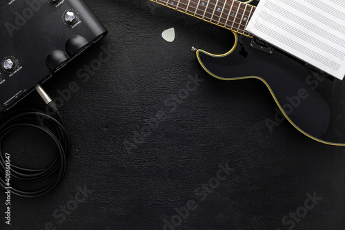Desk of musician for songwriter work set with headphones and guitar