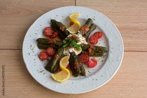 Olive oil lemon vine leaves, top view, turkish sarma or dolma.