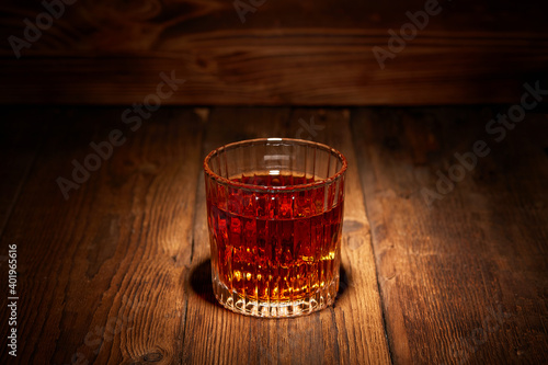 Whiskey in glasses on wooden table