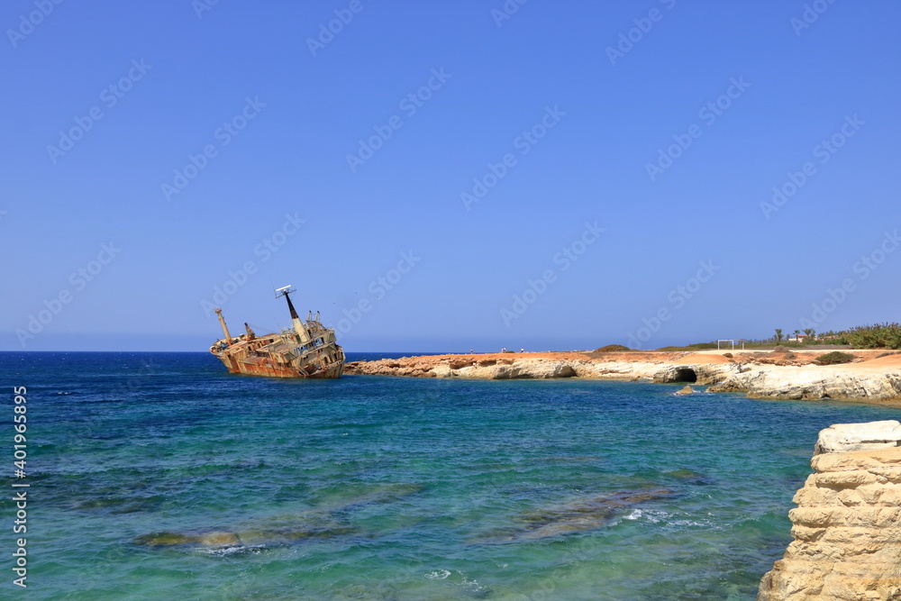 Shipwreck of the abandoned ship Edro III on a rocky coast at Akrotiri Beach in Cyprus