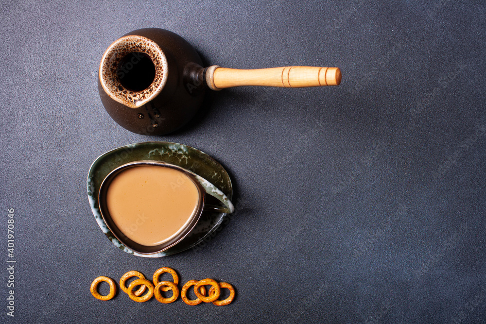Turk, cup of coffee, cookies on a black background. Flat lay.