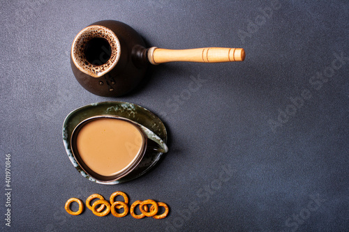 Turk, cup of coffee, cookies on a black background. Flat lay. photo