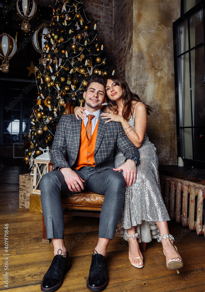 young couple newlyweds laugh rejoice having fun Christmas mood hug tenderness love kiss Christmas tree young couple newlyweds laugh rejoice having fun Christmas mood hug tenderness love kiss Christmas tree