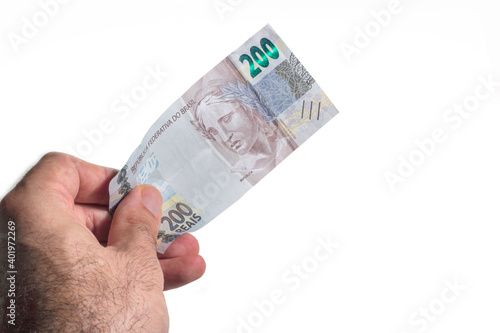Hand holding a brazilian money two hundred real bill