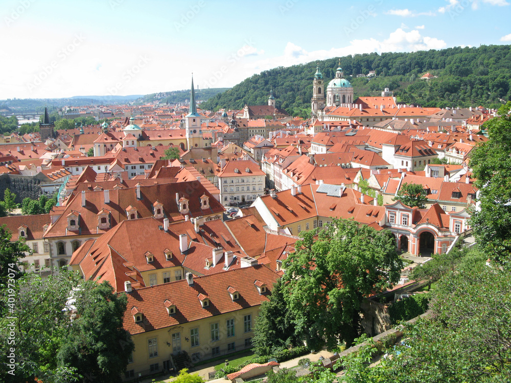 Obraz premium Scenic panoramic view of townscape of the famous Lesser Town of Prague (Mala Strana) on sunny summer day with blue sky in the Prague, Bohemia, Czechia. View from above. UNESCO World Heritage Site.