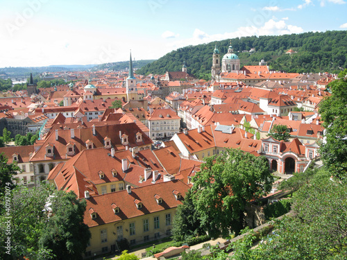 Scenic panoramic view of townscape of the famous Lesser Town of Prague (Mala Strana) on sunny summer day with blue sky in the Prague, Bohemia, Czechia. View from above. UNESCO World Heritage Site.