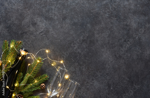 Background in New Year's concept. Decoration with fir and gifts on a black background.