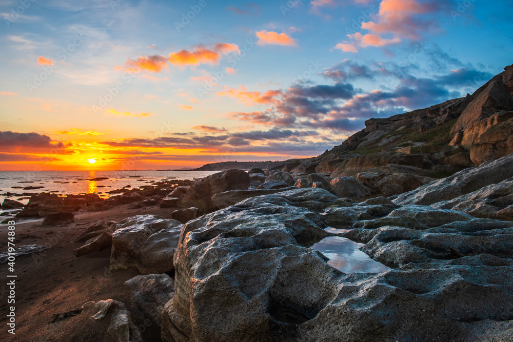 Colorful sunrise on the rocky coast