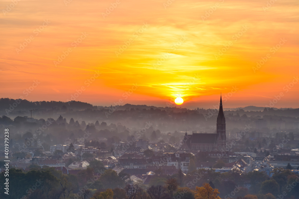 Amazing sunrise over the city of Graz with Church of the Sacred Heart of Jesus and historic buildings in Graz, Styria region, Austria. Amazing sunrise over the city of Graz with Church of the Sacred Heart of Jesus and historic buildings in Graz, Styria region, Austria.