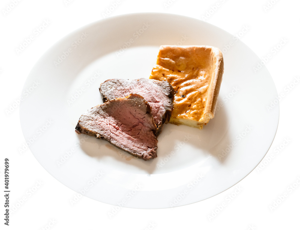 home-made sliced Roast Beef and piece of Yorkshire pudding on white plate cut out on white background home-made sliced Roast Beef and piece of Yorkshire pudding on white plate cut out on white background