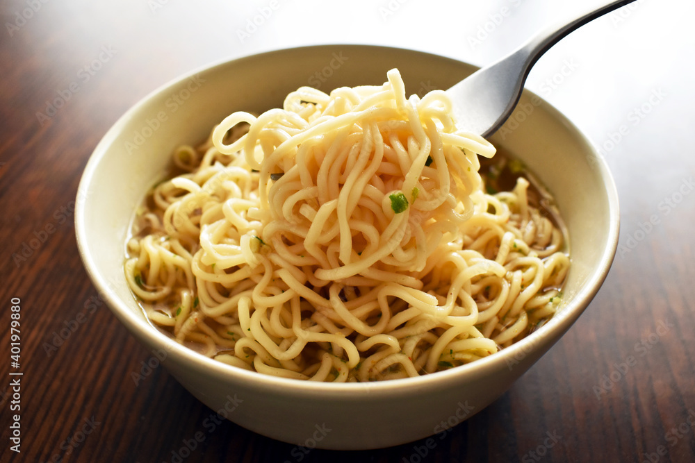 Instant noodles with a fork on a bowl. Instant noodles with a fork on a bowl.