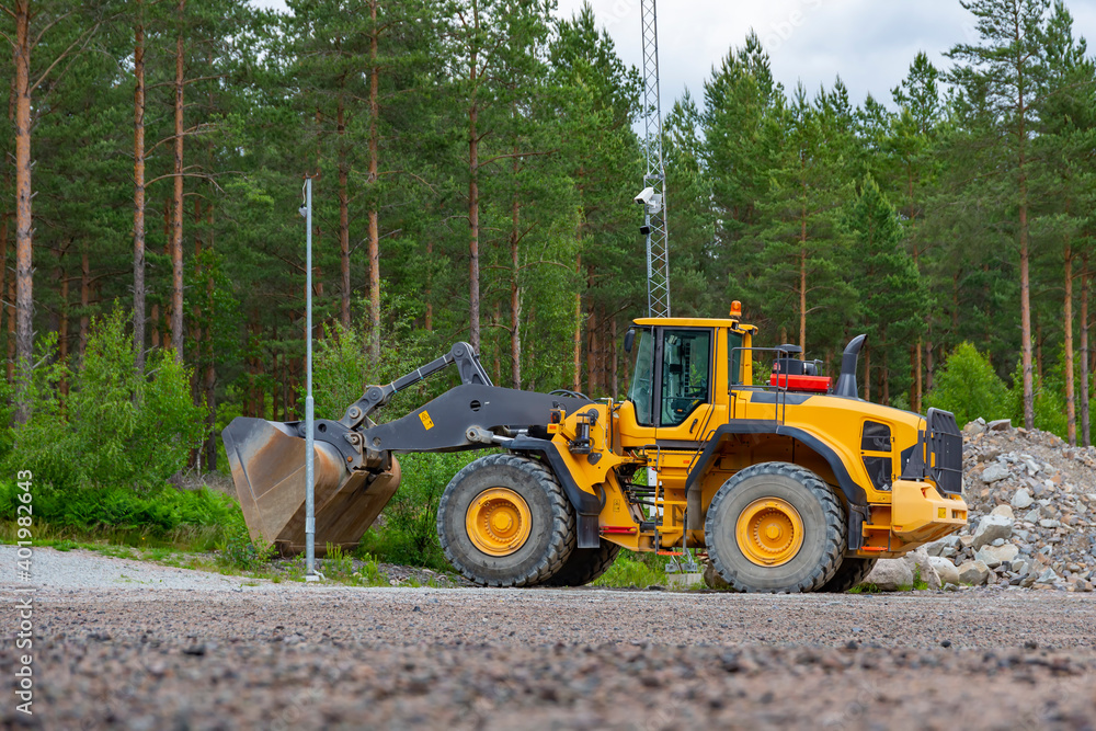 yellow wheel loader bulldozer with huge bucket in the forest road building scene standing in granit rubble yellow wheel loader bulldozer with huge bucket in the forest road building scene standing in granit rubble