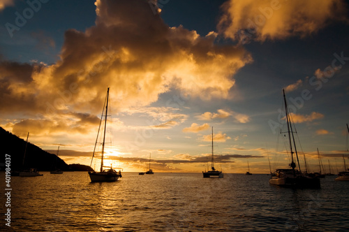 Anchoring ships in tropical bay at sunset. Small yachts and catamarans on sea water during dusk. Santa Lucia. Caribbean lifestyle themes © Digihelion