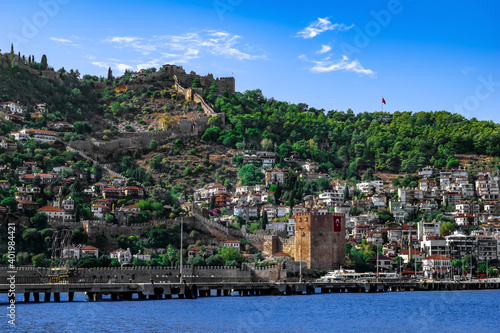 Fototapeta Naklejka Na Ścianę i Meble -  Seascape with Red Tower and Alanya Castle on top of a hill (Turkey). Beautiful landscape with the landmarks of the Turkish resort