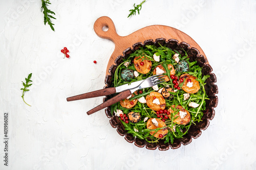 Fresh lettuce with grilled peaches, berries and goat cheese, Delicious snack on a light background, top view, Long banner format