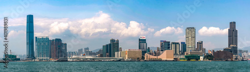 The skyline of West Kowloon and Tsim Sha Tsui on the waterfront with Victoria Harbour - Hong Kong.