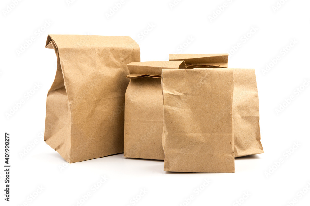 paper disposable bag of brown kraft paper on white background, concept of rejection of plastic packaging, template for designer, packaging for contactless product delivery paper disposable bag of brown kraft paper on white background, concept of rejection of plastic packaging, template for designer, packaging for contactless product delivery