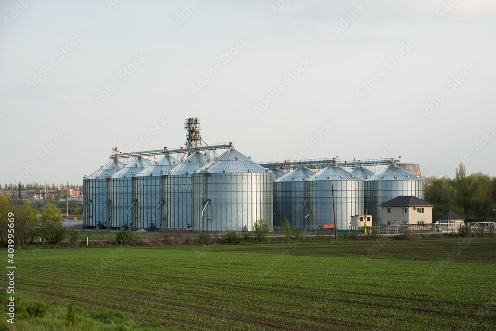 Grain elevators among spring landscape Grain elevators among spring landscape